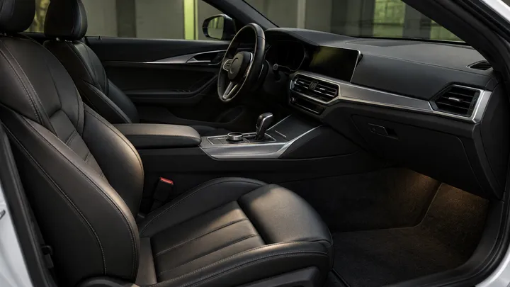 Generated concept detail of a warm black car interior with unbranded silver trim.