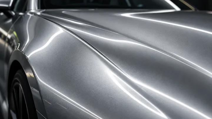 Generated concept macro of silver vehicle paint and soft reflected lighting.